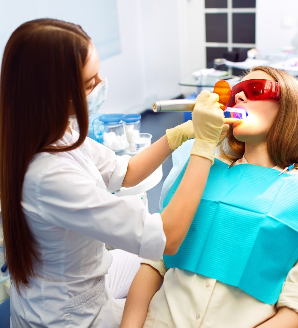 Overview of dental caries prevention. Woman at the dentist's chair during a dental procedure.